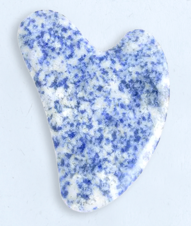 Blue and white stone gua sha tool on a light gray background